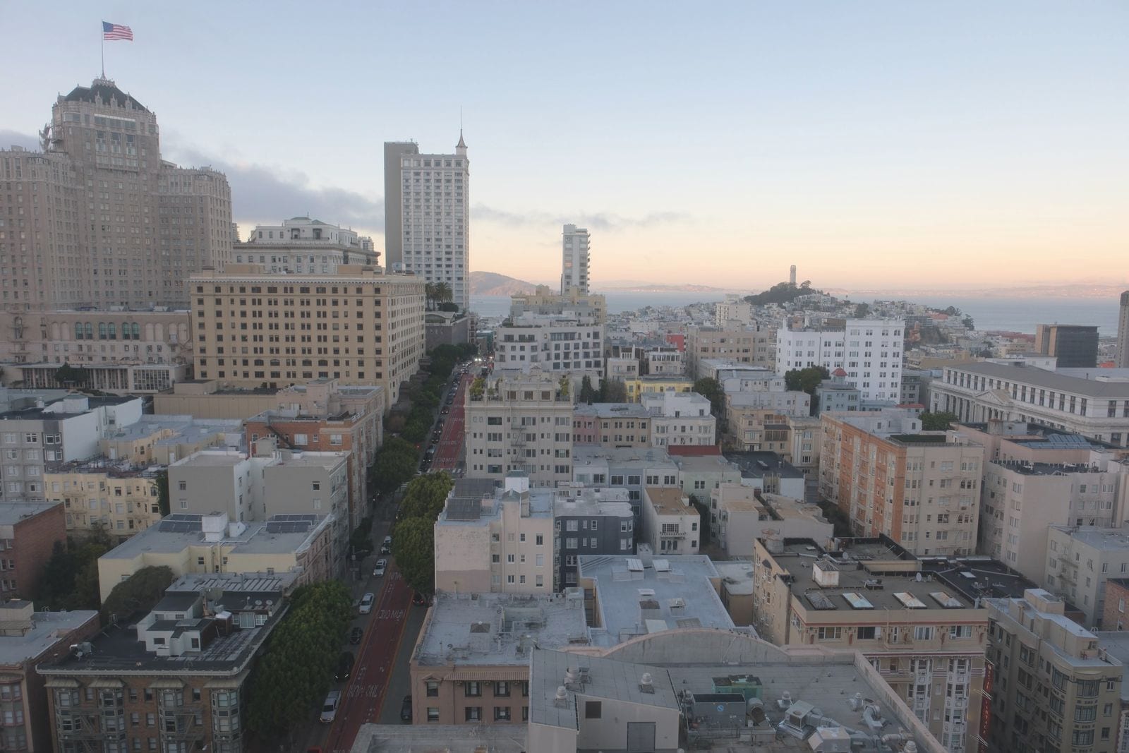 San Francisco rooftops in the morning, a long street running down toward the bay